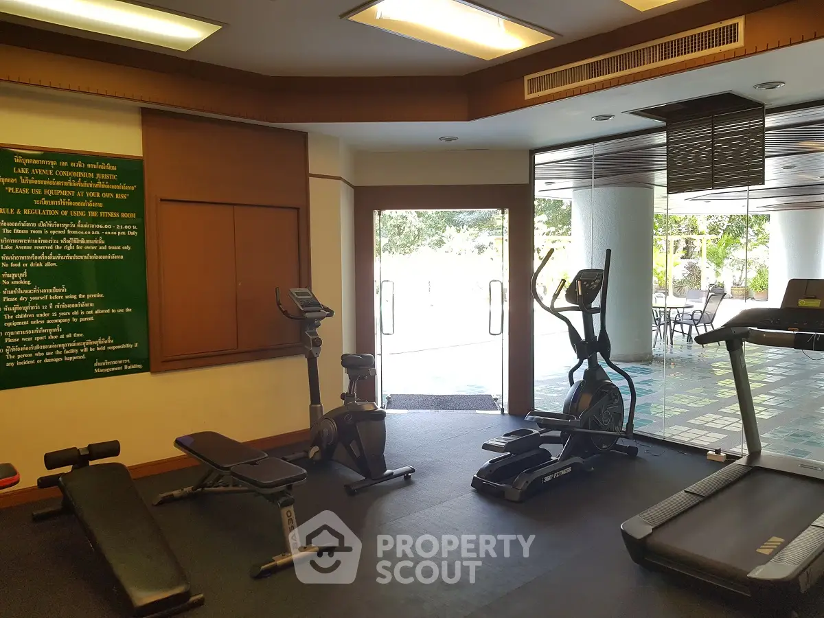 Modern gym with exercise equipment and outdoor view in luxury real estate property.