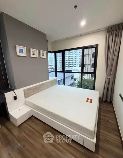 Modern bedroom with large windows and stylish decor in urban apartment