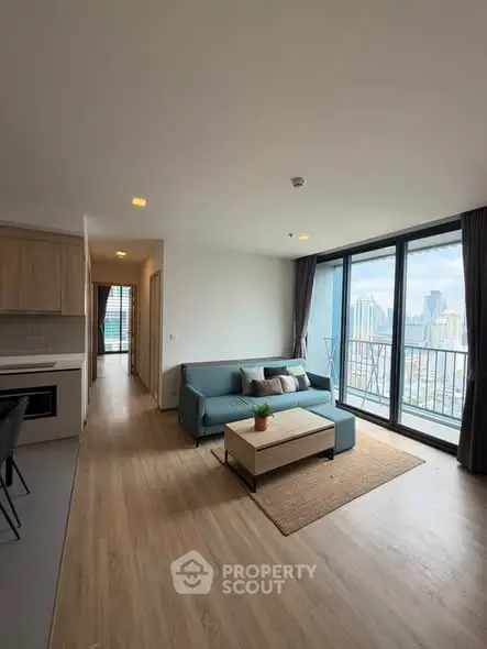 Modern living room with city view and open kitchen layout