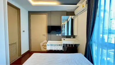 Modern bedroom with large window and air conditioning in urban apartment.