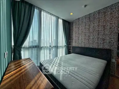 Modern bedroom with large windows and stylish wallpaper, offering ample natural light and a cozy atmosphere.