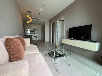 Modern living room with stylish furniture and open kitchen layout in a contemporary apartment.