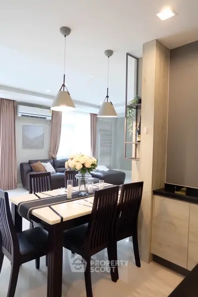 Modern open-plan living and dining area with elegant decor and natural light.