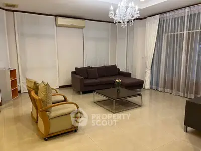 Spacious living room with elegant chandelier and modern furniture