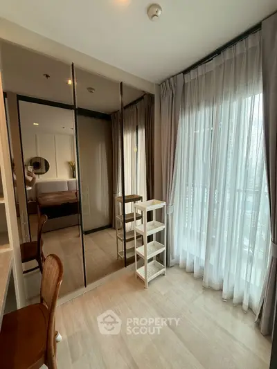 Modern bedroom with floor-to-ceiling windows and mirrored closet doors