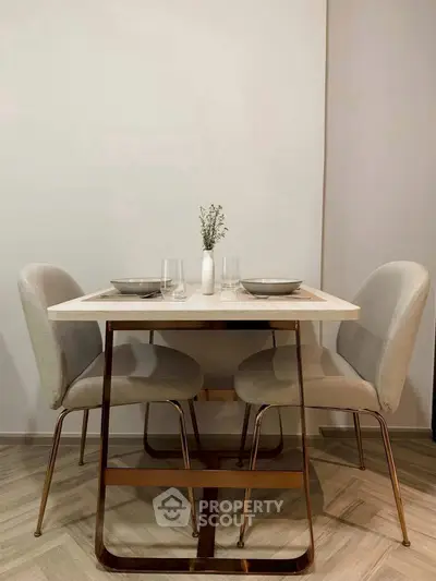 Elegant dining area with modern table and chairs, perfect for cozy meals.