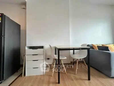 Modern apartment interior with dining area and cozy living room setup.