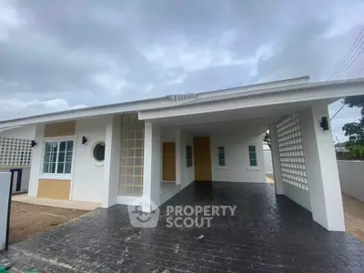 Modern single-story home with spacious carport and stylish exterior design.