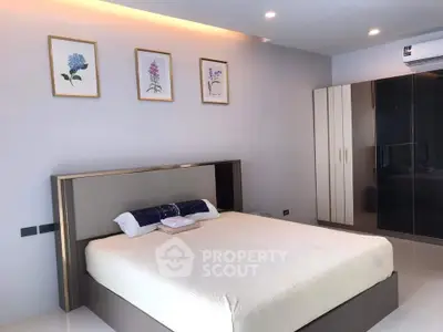 Modern bedroom with sleek design, featuring a comfortable bed, stylish wardrobe, and elegant wall art.