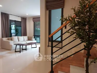 Modern living room with stylish staircase and cozy seating area