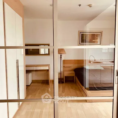 Modern bedroom with glass sliding doors and stylish wooden furniture