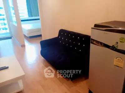 Modern apartment interior with cozy living room and bedroom, featuring stylish furniture and natural light.