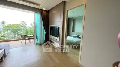 Luxurious beachfront condo with spacious living room and private balcony offering stunning ocean views.