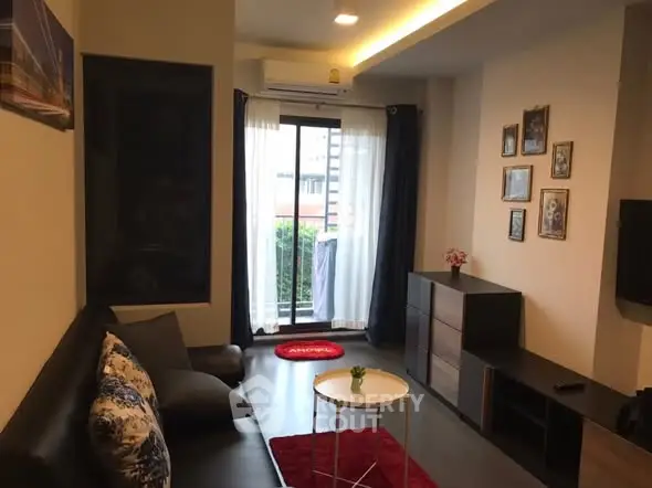 Modern living room with stylish decor and balcony view, perfect for urban living.