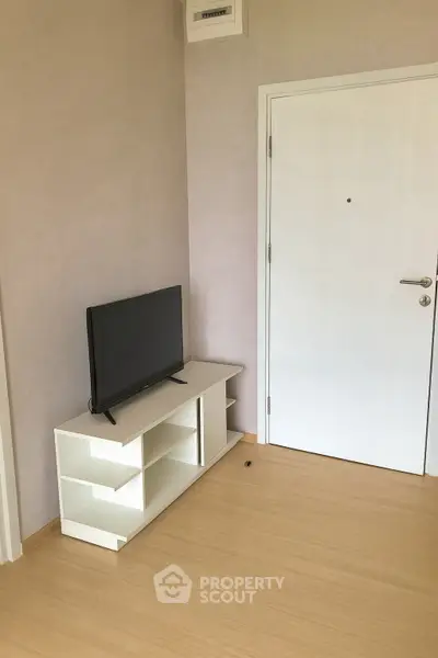 Minimalist living room with TV stand and modern door