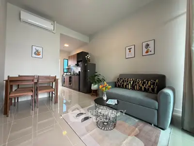 Modern living room with sleek furniture and open kitchen layout