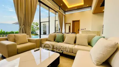 Luxurious living room with modern decor and large windows offering natural light.