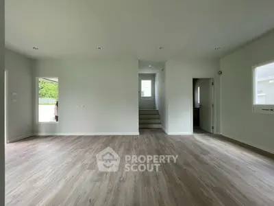 Spacious empty room with modern flooring and natural light