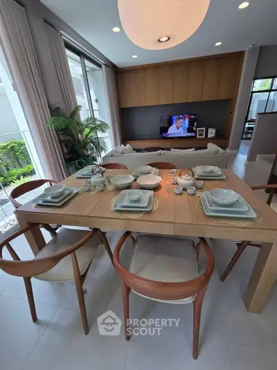 Modern dining area with elegant table setting and cozy living room ambiance