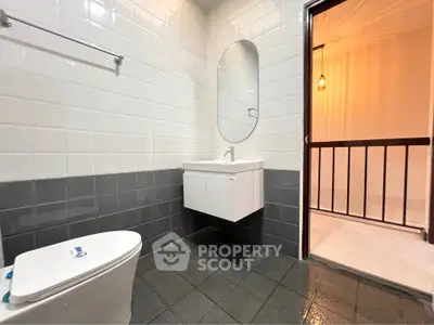 Modern bathroom with sleek design and contemporary fixtures in a stylish apartment.