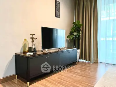 Modern living room with sleek TV stand and large window curtains