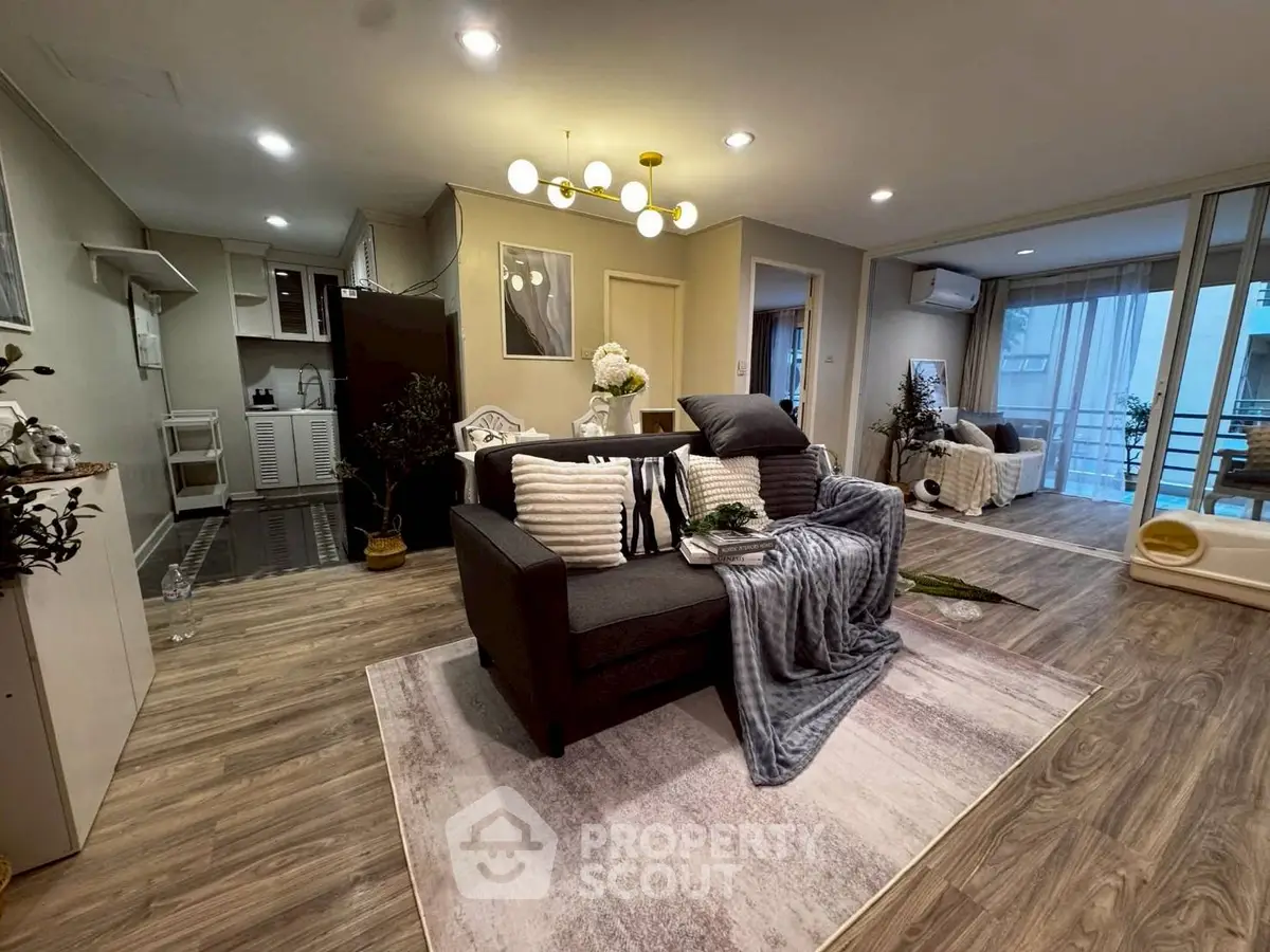 Spacious modern living room with elegant decor and open layout, featuring cozy seating and stylish lighting.