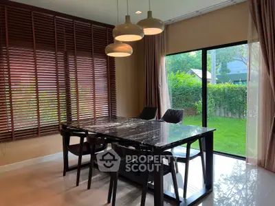 Elegant dining area with marble table and garden view, perfect for modern living.