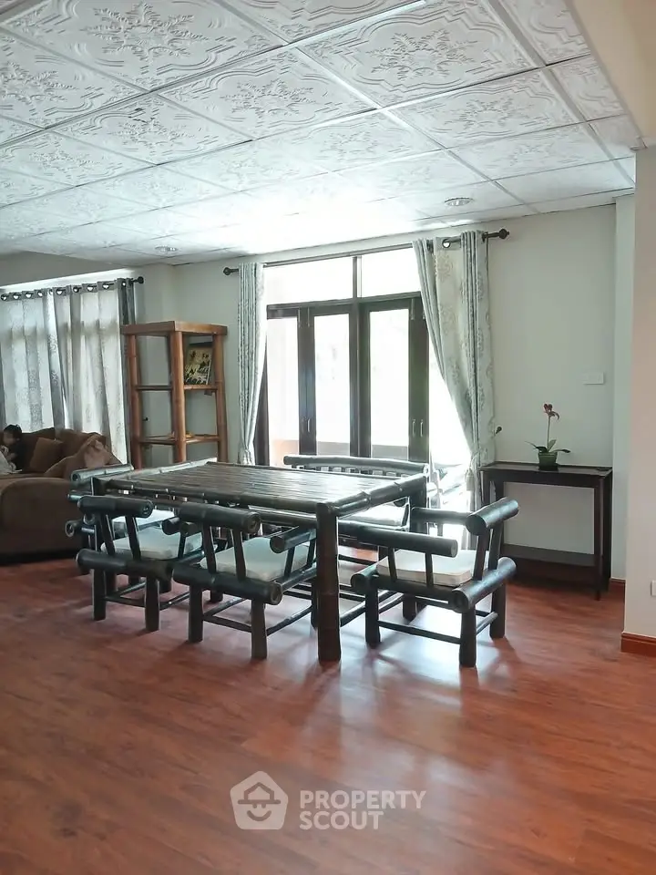 Spacious living room with elegant bamboo furniture and large windows