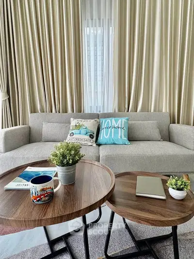 Stylish living room with cozy sofa and chic coffee tables, perfect for relaxation.