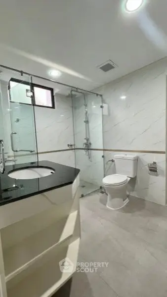 Modern bathroom with glass shower and sleek fixtures