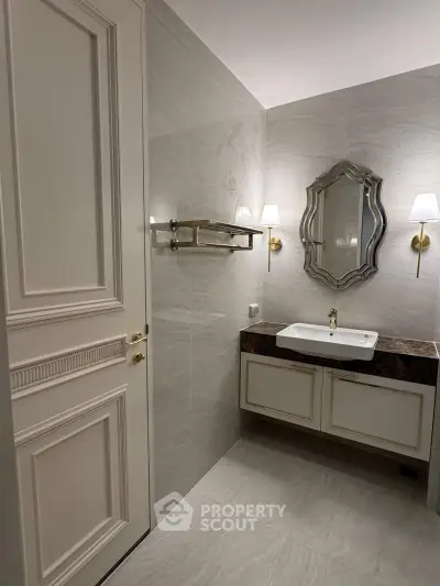 Elegant bathroom with stylish mirror and modern fixtures in luxury real estate property.