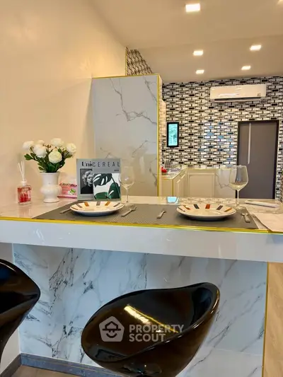 Modern kitchen with sleek marble countertops and stylish bar stools