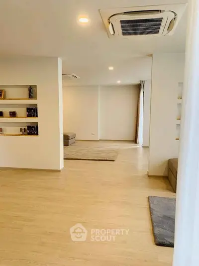 Spacious modern living room with built-in shelves and cozy seating area