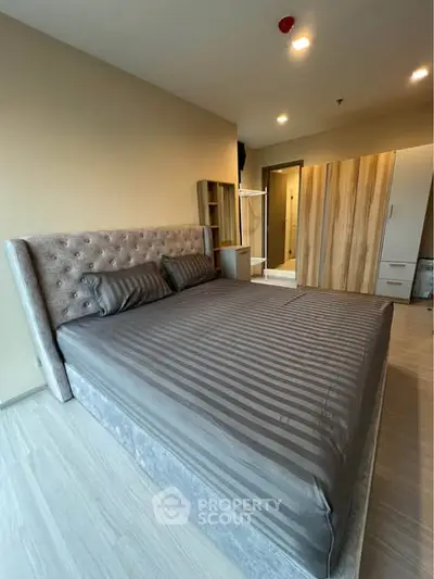 Modern bedroom with stylish bed and ample wardrobe space
