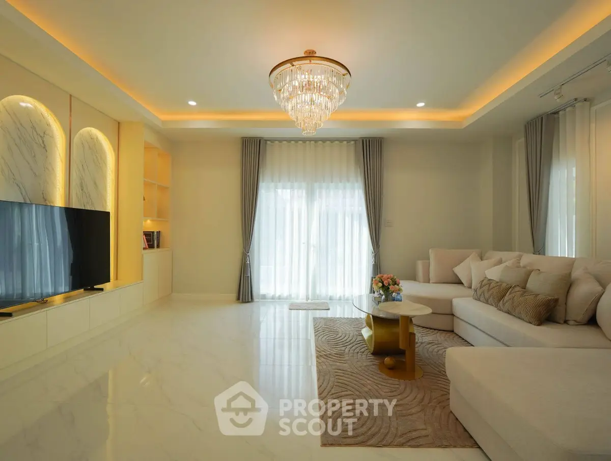 Luxurious living room with elegant chandelier and modern decor