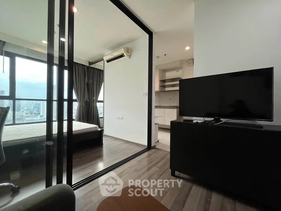 Modern apartment with glass partition, city view, and sleek furnishings