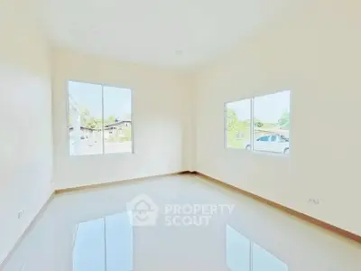 Bright and spacious empty room with large windows and glossy tiled floor, perfect for customization.