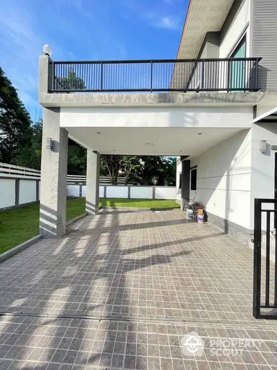 Modern two-story house with spacious driveway and lush green garden