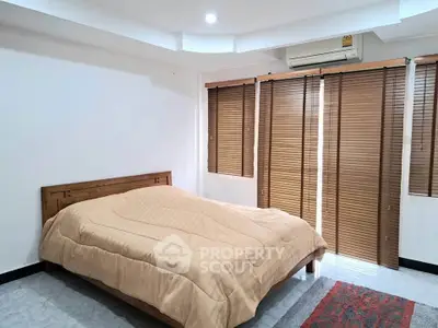Cozy bedroom with wooden blinds and modern decor