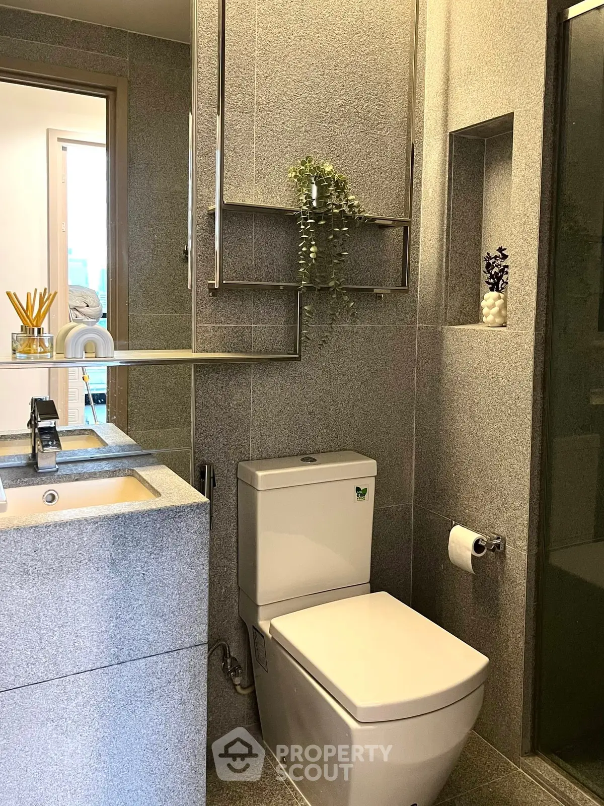 Modern bathroom with sleek fixtures and elegant design, featuring a stylish sink and toilet.