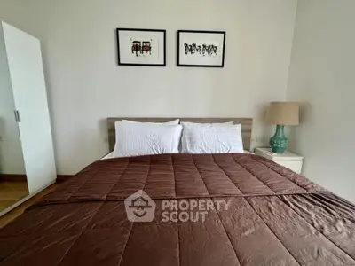 Cozy bedroom with modern decor, featuring a comfortable bed and stylish artwork on the wall.