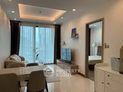 Modern living room with elegant decor and city view from balcony.