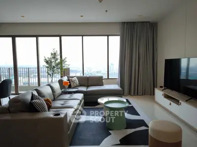 Spacious modern living room with large windows and city view