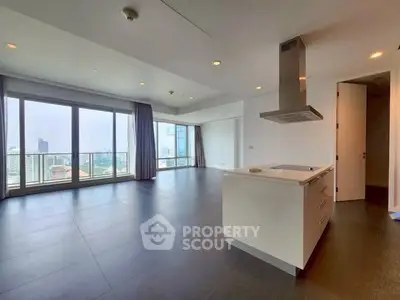 Spacious modern living room with open kitchen and city view