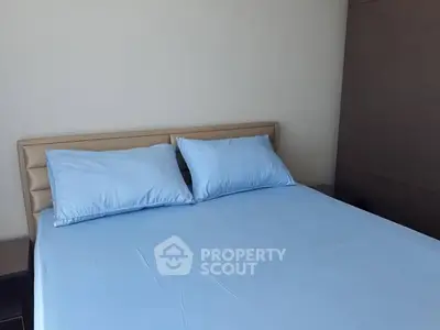 Cozy bedroom with blue bedding and modern headboard