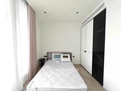 Modern minimalist bedroom with sleek wardrobe and natural light