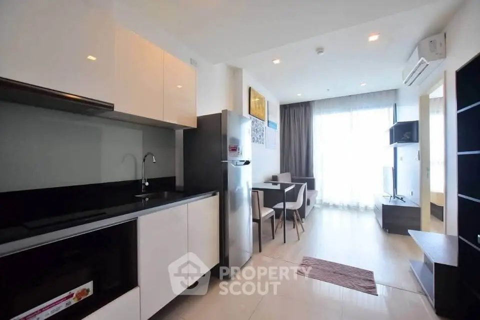 Modern open-plan kitchen and living area with sleek design and natural light.