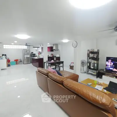 Spacious open-plan living room with modern kitchen and cozy seating area.