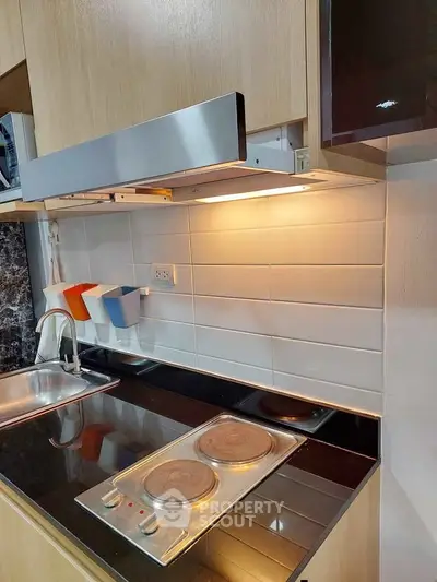 Modern kitchen with electric stove and sleek cabinetry