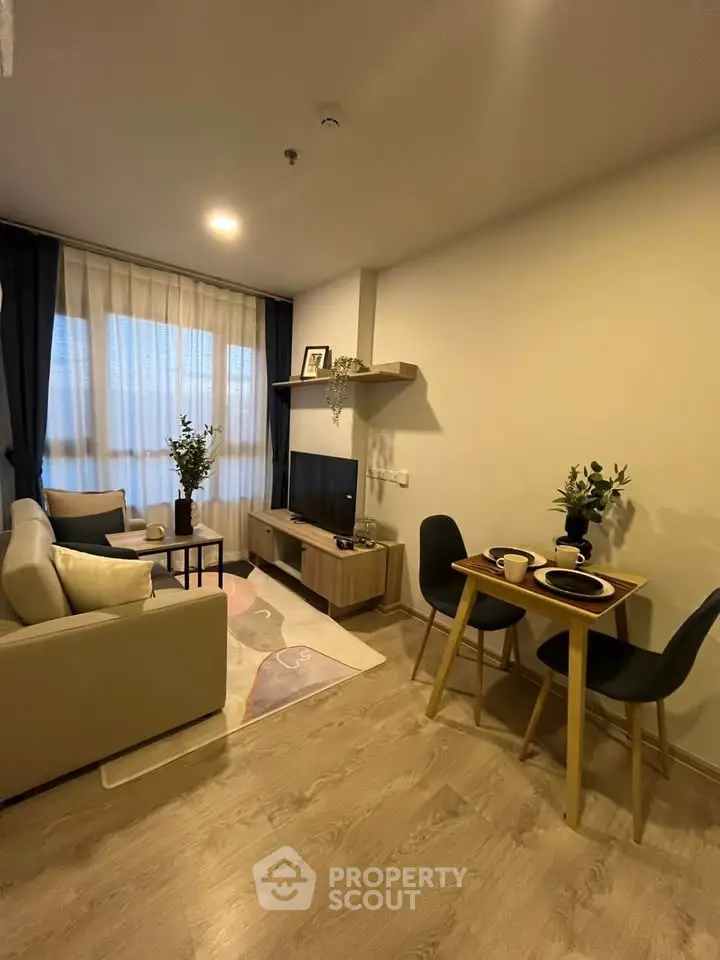 Cozy modern living room with stylish decor and dining area, perfect for urban living.